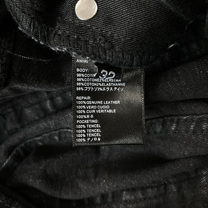 AMIRI VARSITY LOGO REPAIR JEANS