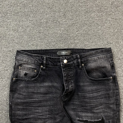AMIRI VARSITY LOGO REPAIR JEANS